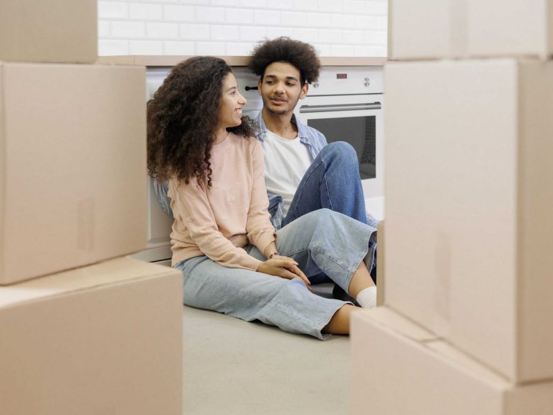 Young couple sitting with moving boxes