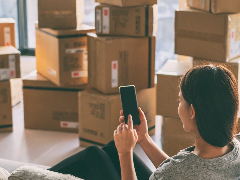 Moving,Boxes,Woman,Using,Phone,Panoramic,For,Move,To,College